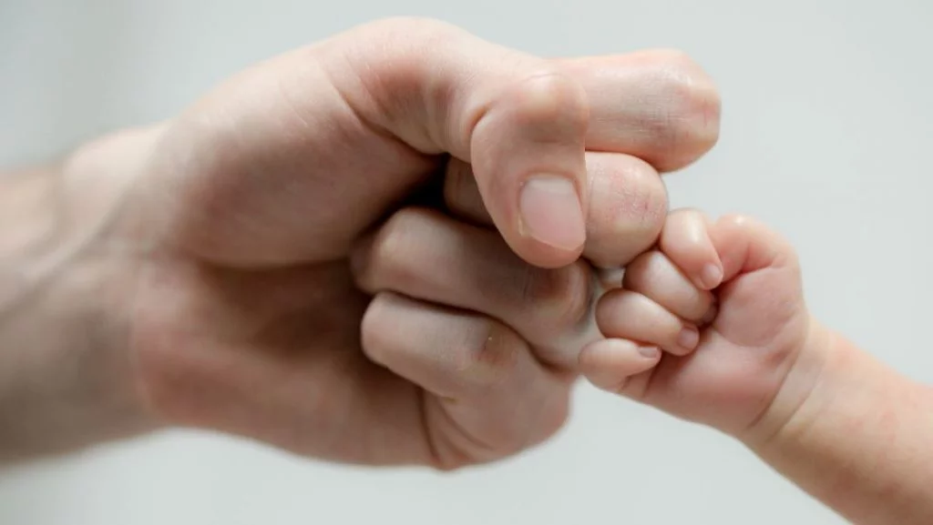 Close up of Father fist bumping child