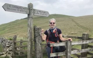 Sarah Kaplan stands next to a directional sign