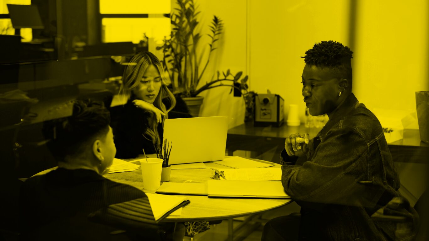 A group of co-workers of varying genders having a meeting